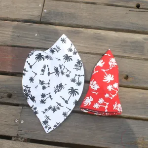 Detailed view of cotton bucket hat with tropical palm tree print, stylish summer sun hat.