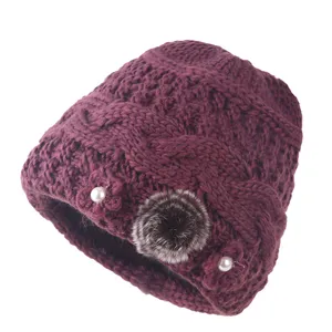 Warm winter knitted hat for elderly women, vintage plush pom-pom and pearl flower details.
