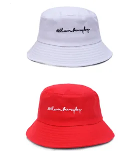 Detailed view of casual unisex bucket hats in white and red with front embroidery design.