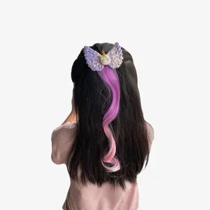 Detail view of children unicorn wing hair clip with colorful gradient wig braid extension.
