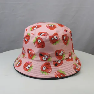 Detailed view of pink cute cartoon strawberry print bucket hat, stylish cotton fabric brim.
