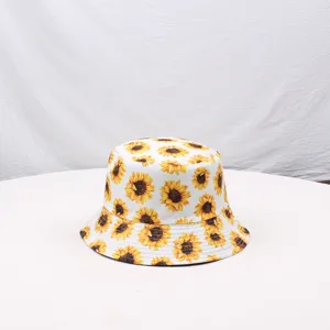 Detailed close-up view of the sunflower printed pattern on the white cotton bucket hat fabric.