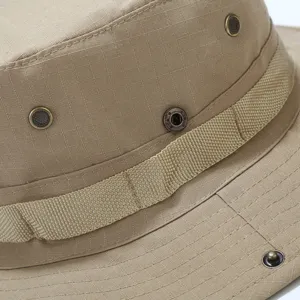 Khaki tactical boonie hat detail showing grid fabric, metallic ventilation eyelets, strap.