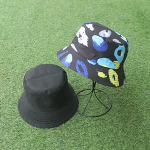 Reversible bucket hat with abstract print and solid black design, ideal for outdoor sun protection.