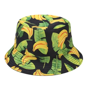 Close-up detail of the vibrant yellow banana and green leaf all-over print bucket hat texture.