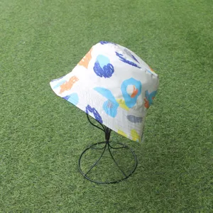 Close-up view of a stylish white bucket hat featuring colorful abstract brushstroke patterns.