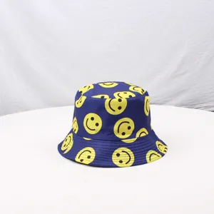 Close-up detail of the classic blue bucket hat featuring vibrant yellow smiley face prints.