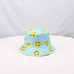 Detailed view of the light blue bucket hat featuring playful yellow smiley face prints.