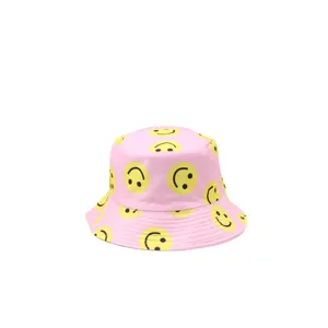 Pink bucket hat with yellow smiley face print, casual summer sun protection outdoor hat.