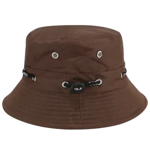 Closeup of brown bucket hat detail showing adjustable drawstring and metal eyelets for ventilation.