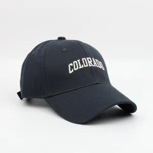Close-up detail of dark baseball cap with white embroidered Colorado letter design.