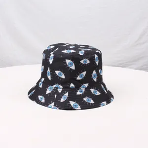 Black printed bucket hat detail showing blue eye pattern fabric texture and neat stitching.