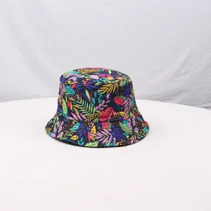 Colorful botanical leaf print bucket hat detail shot, showing vibrant fabric pattern and texture.