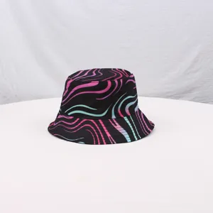 Close-up detail of the colorful wavy striped bucket hat showing the vibrant pink and blue pattern.