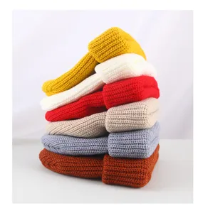 Stacked solid color winter knitted beanies detail showing multi-color fashion knit caps.