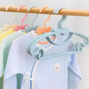 Durable plastic baby clothes hangers with cute bow design, perfect for infant garments and home use.