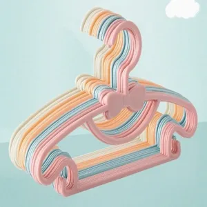 Children plastic clothes hangers with bow design, detail view showing cute pastel colors.