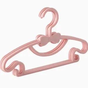 Pink plastic children hangers with bow, ideal for baby clothes drying and daily wardrobe storage.