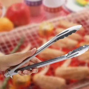 Detail view of a stainless steel food tong in use, perfect for kitchen barbecue and baking.