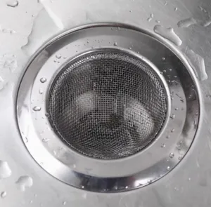 Stainless steel sink strainer detail close up, fine mesh kitchen drain filter for daily use.