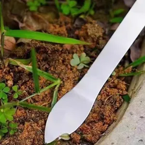 Stainless steel bonsai tool detail, professional soil compacting and weeding rake, durable.