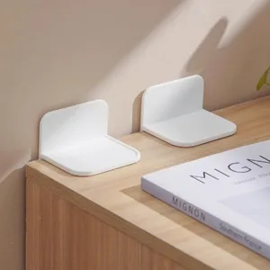 Detail view of white anti-tipping furniture brackets, punch-free design for cabinet safety.