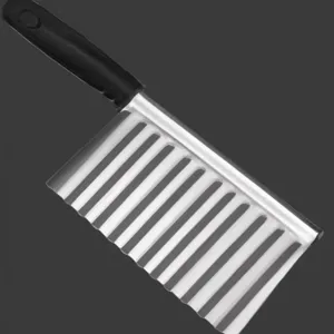 Close-up of stainless steel crinkle cutter blade with ergonomic black handle for kitchen slicing.