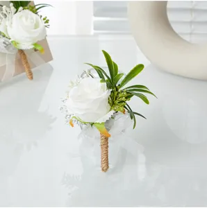 Artificial white rose boutonniere with green leaves and jute handle for wedding party groom.