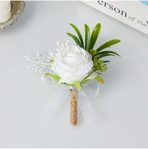 Elegant white artificial rose wedding boutonniere with burlap stem and bow detail for men.