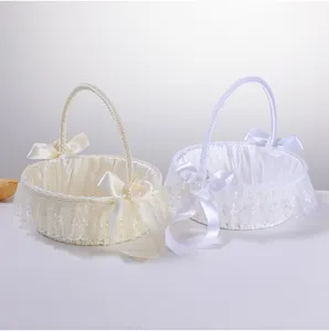 Elegant western style wedding flower girl basket with lace bow and handle for ceremony.