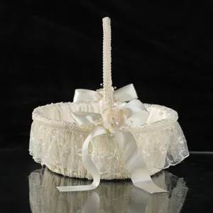 Elegant ivory wedding flower girl basket with lace trim, satin bows, and pearl accents.