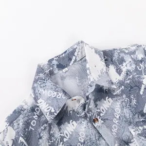 Close-up detail of mens casual short sleeve Hawaiian shirt collar with letter print.