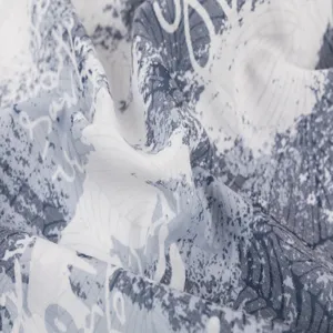 Close-up detail of blue and white abstract printed fabric, showing soft texture and pattern.
