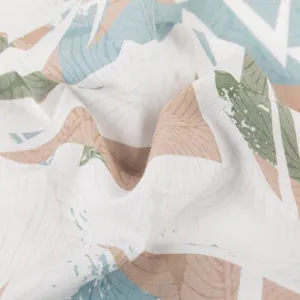 Close-up detail of tropical botanical leaf print fabric for summer casual wear apparel.