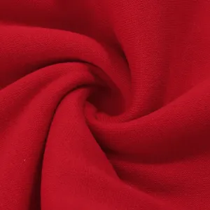 Red thick fleece sweatpants fabric close-up view, showing soft and warm texture details.