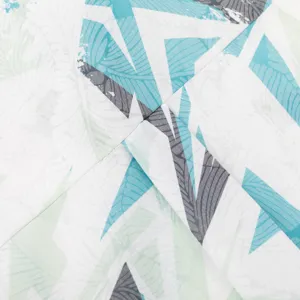 Close-up detail of men's casual Hawaiian short sleeve printed shirt fabric, abstract pattern.