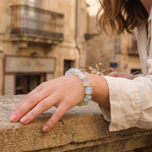 Close-up detail of a minimalist irregular translucent stone bead bracelet worn gracefully on wrist.