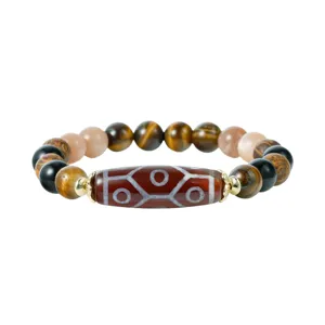 Close-up detail of Tibetan style multi-gemstone beaded bracelet with vintage carved centerpiece.