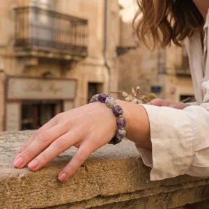 Detailed close-up view of an irregular block stone bracelet worn on the wrist, showcasing style.