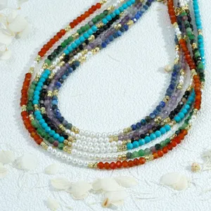 Close-up macro detail of colorful gemstone and pearl beaded necklace, handmade fashion.
