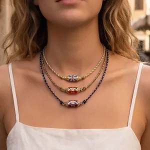 Layered braided necklace featuring colorful hexagonal evil eye pendants for trendy styles.