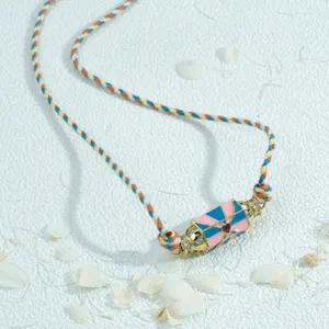 Detailed view of the colorful braided rope necklace with a unique hexagonal prism crystal pendant.