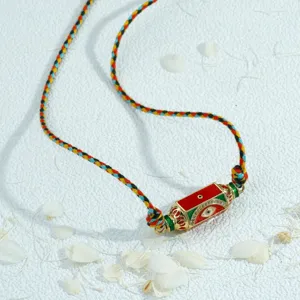 Closeup view of the handmade colorful braided rope necklace with hexagonal evil eye pendant.