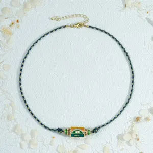 Handmade braided evil eye necklace with colorful enamel hexagonal prism pendant for women.