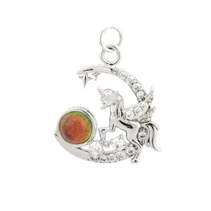 Close-up of silver-tone star moon unicorn charm pendant with sparkling cubic zirconia and stone.
