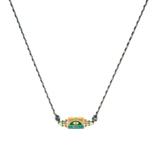 Close-up view of the colorful hexagonal evil eye pendant jewelry detail with woven cord.