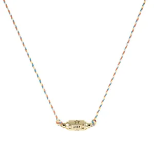 Detailed view of the colorful braided cord necklace featuring a gold cylindrical lucky pendant.