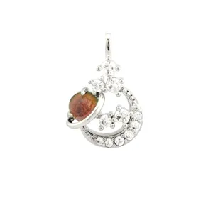 Close-up detail of the celestial star and moon planet charm pendant with sparkling cubic zirconia.