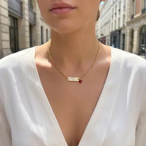 Gold-plated copper necklace featuring a rhinestone paved bar pendant and a red heart charm for women.
