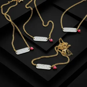 Gold-plated copper alphabet tag necklaces with sparkling cubic zirconia and red heart charms detail.